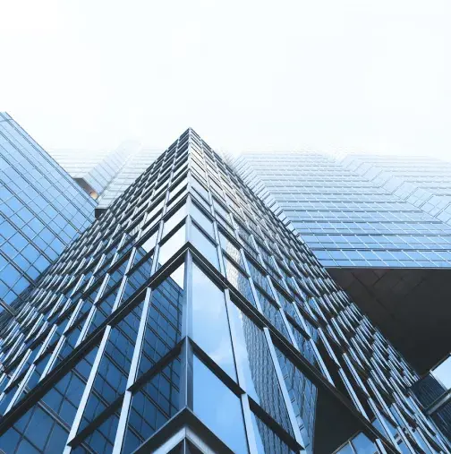 Modern glass office building viewed from below